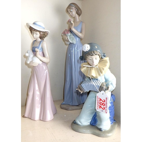 282 - Two small Lladro figures with blankets together with 7 Nao figures (9)