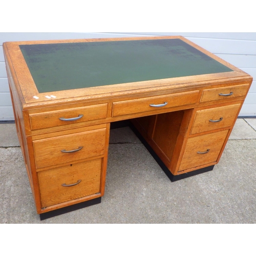 780 - A 1930's light oak office desk with inset top, 130cm wide