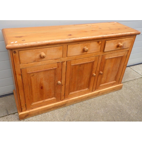 813 - A three door pine dresser base, 154cm wide