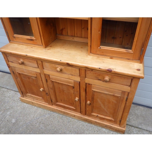 815 - A pine three door dresser with glazed upper section, 155cm wide