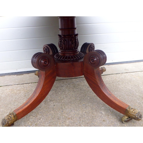 821 - A 19th cen mahogany breakfast table with sectioned top on turned and carved base with brass castors,... 