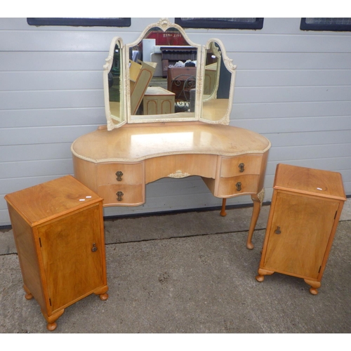 825 - A 1950's bleached walnut kidney shaped dressing table, 126cm wide together with a similar pair of be... 