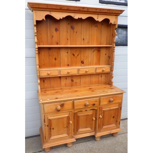 848 - A modern pine dresser with rack, 129cm wide