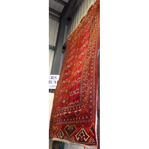 889 - A large red ground rug 190 x 290cm