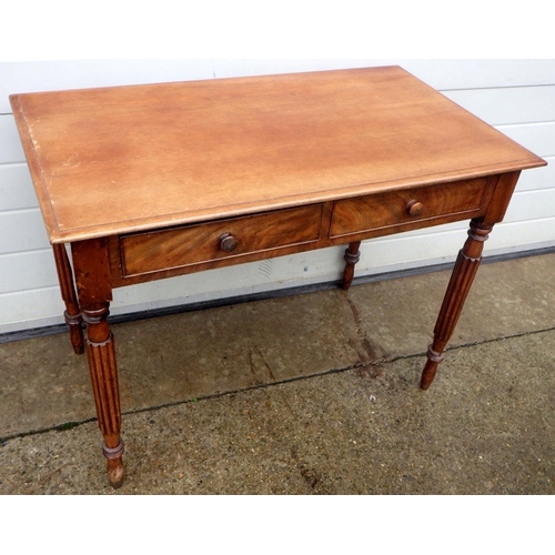 893 - A mahogany two drawer side table on reeded legs, 97cm wide