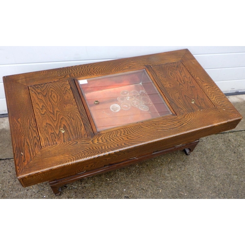 859 - An Oriental coffee table with glass central panel, 109cm long