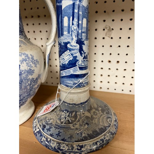 89 - A large early 19th C transfer rinted candlestick together with a Temple blue & white jug (2)