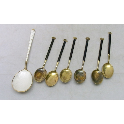 17 - A cased set of gilt white metal and enamel coffee spoons with a matching dessert-shaped spoons, Elgo... 