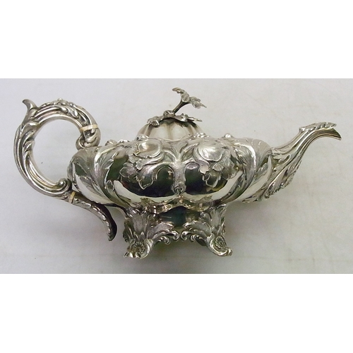 23 - A William IV repousse and chased teapot with matching two handled bowl, both bearing matching engrav... 