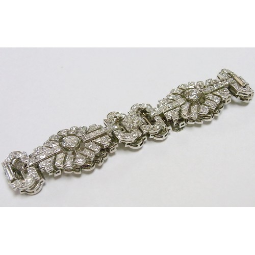 30 - A fancy panel bracelet comprising mixed round cut diamonds in a white metal setting, French bearing ... 