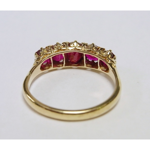 34 - An eternity ring comprising five graduated oval cut rubies and eight small rose cut diamonds in a ye... 