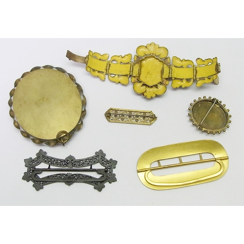 49 - An iron belt buckle  by C Geiss, Berlin, 89mm long; an enamelled belt buckle; a porcelain enamel and... 