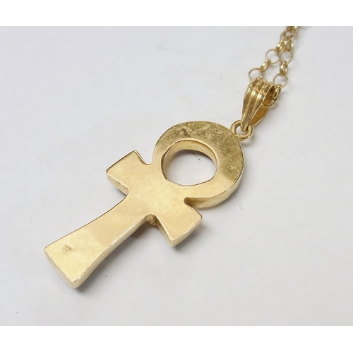 76 - An Ankh motif pendant, Egyptian yellow metal bearing assay mark set with lapis stones, 42mm long, th... 