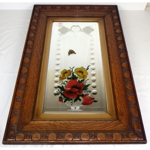 47 - An oak framed mirror together with a modern bevelled mirror (2)