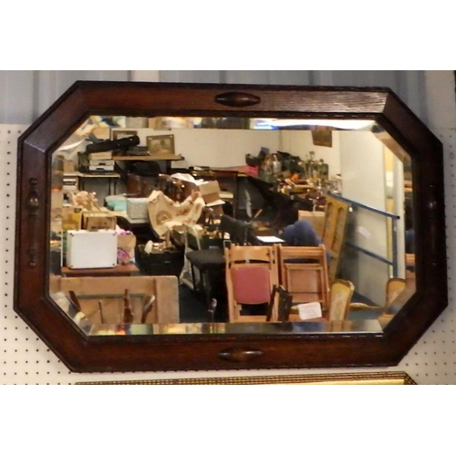 54 - A 1930s oak framed bevelled mirror together with a further mirror (2)