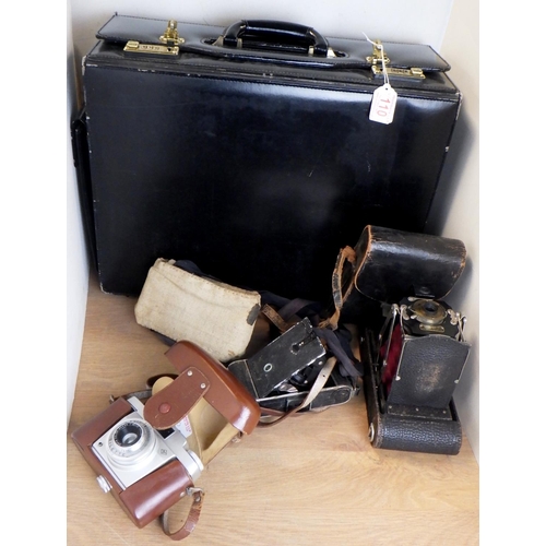 110 - Three vintage cameras and a briefcase