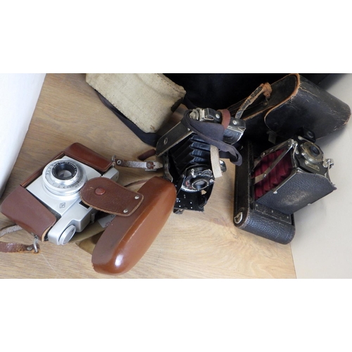 110 - Three vintage cameras and a briefcase