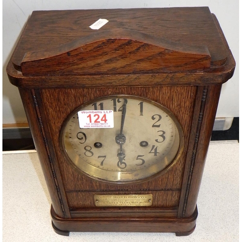 124 - A 1920s oak striking mantle clock, 'Presented to Miss G Griffiths for her three years of war work' 3... 