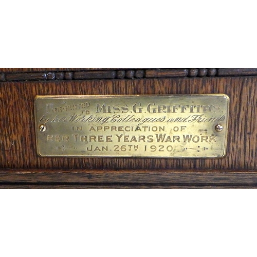 124 - A 1920s oak striking mantle clock, 'Presented to Miss G Griffiths for her three years of war work' 3... 