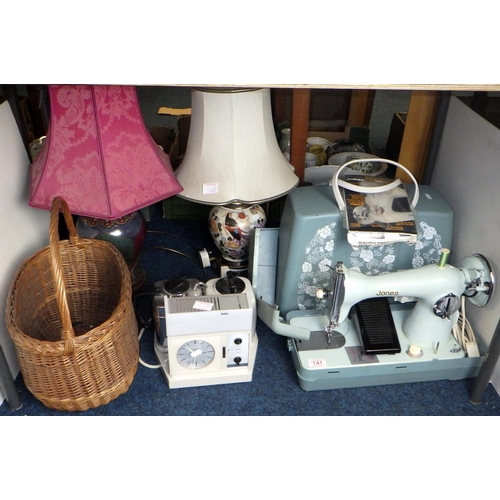 141 - A Jones electric sewing machine together with two lamps, teasmaid and a wicker basket