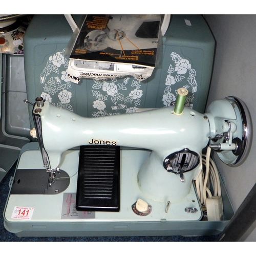 141 - A Jones electric sewing machine together with two lamps, teasmaid and a wicker basket