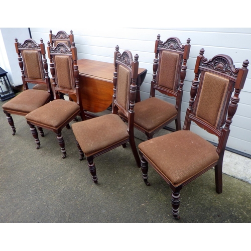 722 - A mahogany drop leaf table, together with six chairs, missing some castors