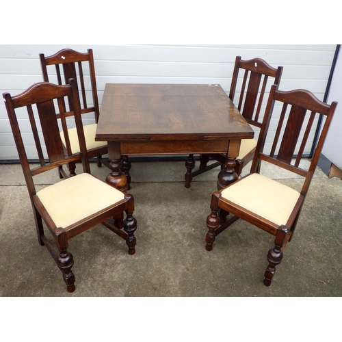 618 - A 1930's oak draw leaf table & four chairs