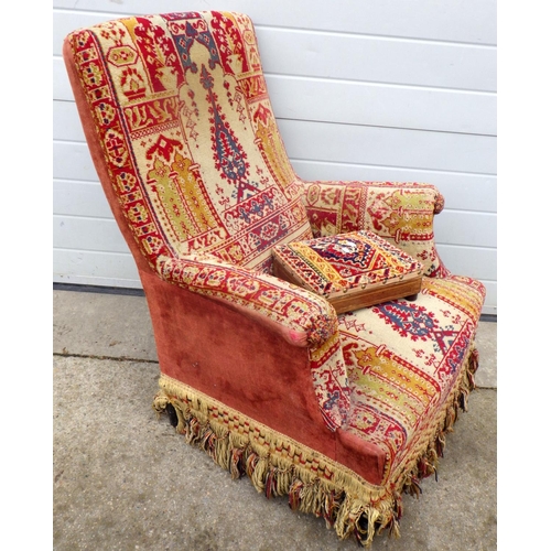 622 - A 19th cen upholstered armchair together with a footstool, a/f worm