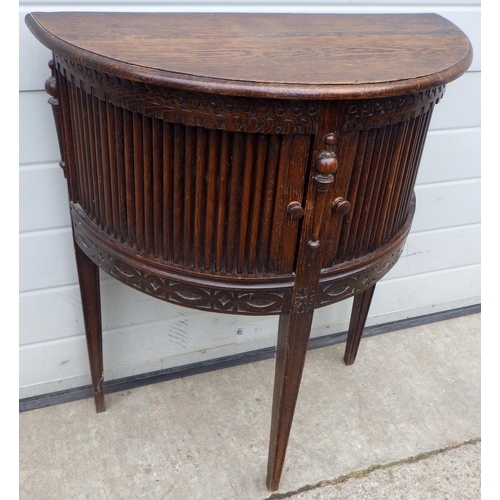 650 - An oak demi-lune side table with tambour front, knob chipped, tambour sticks, 65cm wide