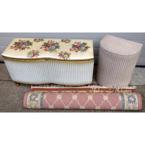 666 - A Lloyd loom ottoman, linen basket and a rug (3)