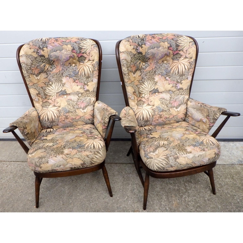 669 - A pair of dark Ercol armchair frames