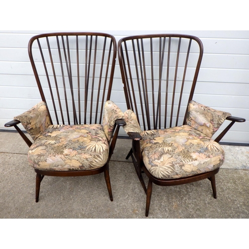 669 - A pair of dark Ercol armchair frames