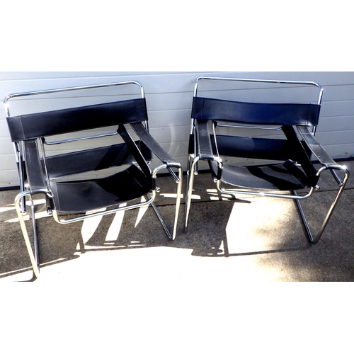 682 - A pair of tubular chrome easy chairs with black seats, in the manner of Wassily