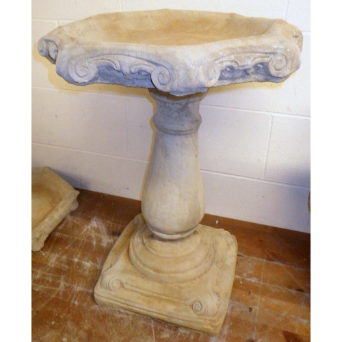 686 - A concrete bird bath with baluster column and octagonal top, approx 67cm tall