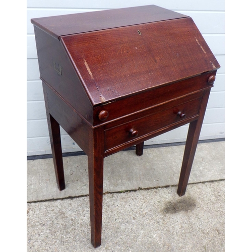 691 - An oak bureau, with campaign style carrying handles on stand with a a single drawer 63cm wide, marks