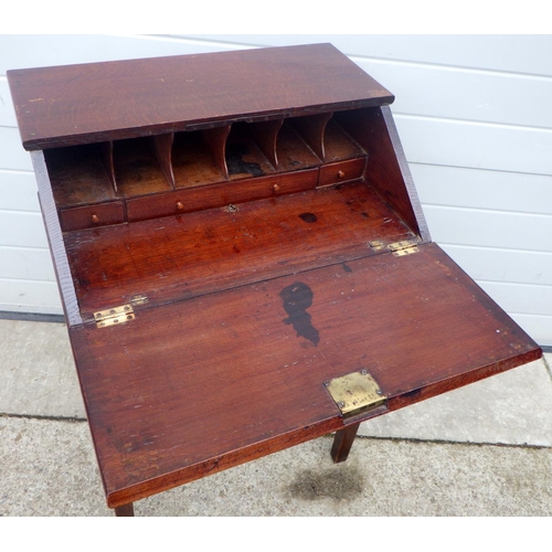 691 - An oak bureau, with campaign style carrying handles on stand with a a single drawer 63cm wide, marks