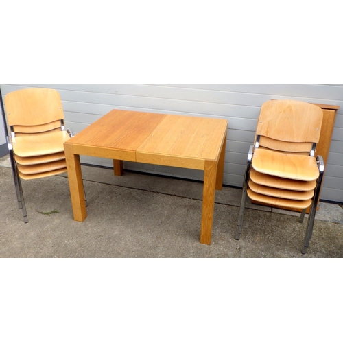 692 - A modern light oak table with two leaves, 234cm long extended, together with eight stacking office c... 