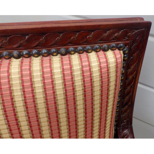 696 - A reproduction Edwardian style upholstered armchair