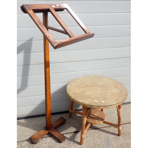704 - A Lloyd Loom circular coffee table, 59cm across together with a music stand (2)