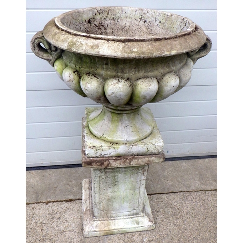 A large concrete garden urn on stand, 117cm tall