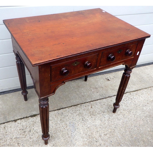 759 - A mahogany two drawer side table on reeded legs, 77cm wide