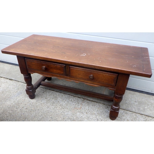 769 - An oak two drawer coffee table, 114cm wide together with a side loading oak nest of occasional table... 
