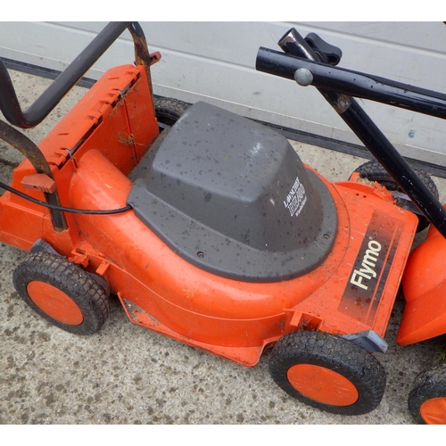 782 - A Flymo petrol lawnmower, together with a Flymo electric lawnmower, both on wheels