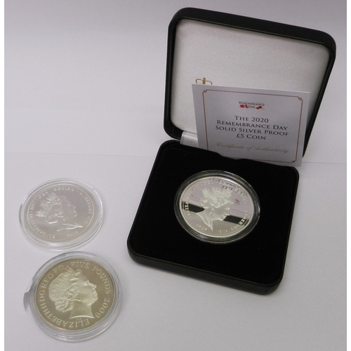 305 - A Jubilee Mint Alderney 2020 silver £5 Remembrance Day coin, cased; two other commemorative £5 coins... 