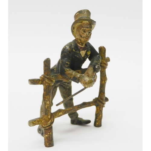 322 - A gentleman in a top hat leaning over a gate, cold painted bronze, unsigned.  75mm tall