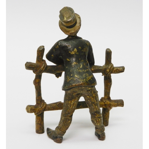 322 - A gentleman in a top hat leaning over a gate, cold painted bronze, unsigned.  75mm tall