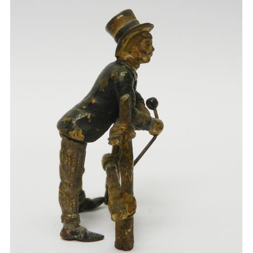 322 - A gentleman in a top hat leaning over a gate, cold painted bronze, unsigned.  75mm tall