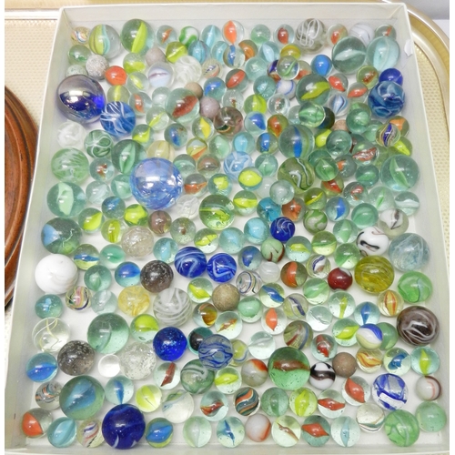 327 - A collection of  glass marbles together with a turned wood solitaire board.