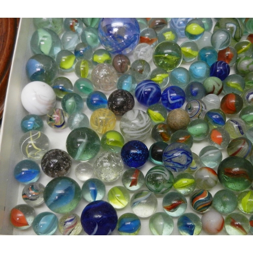 327 - A collection of  glass marbles together with a turned wood solitaire board.