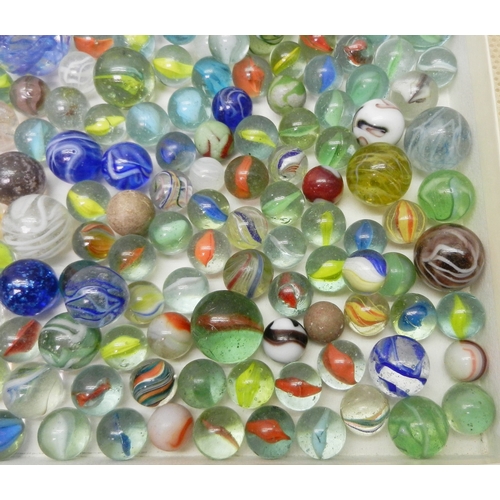 327 - A collection of  glass marbles together with a turned wood solitaire board.